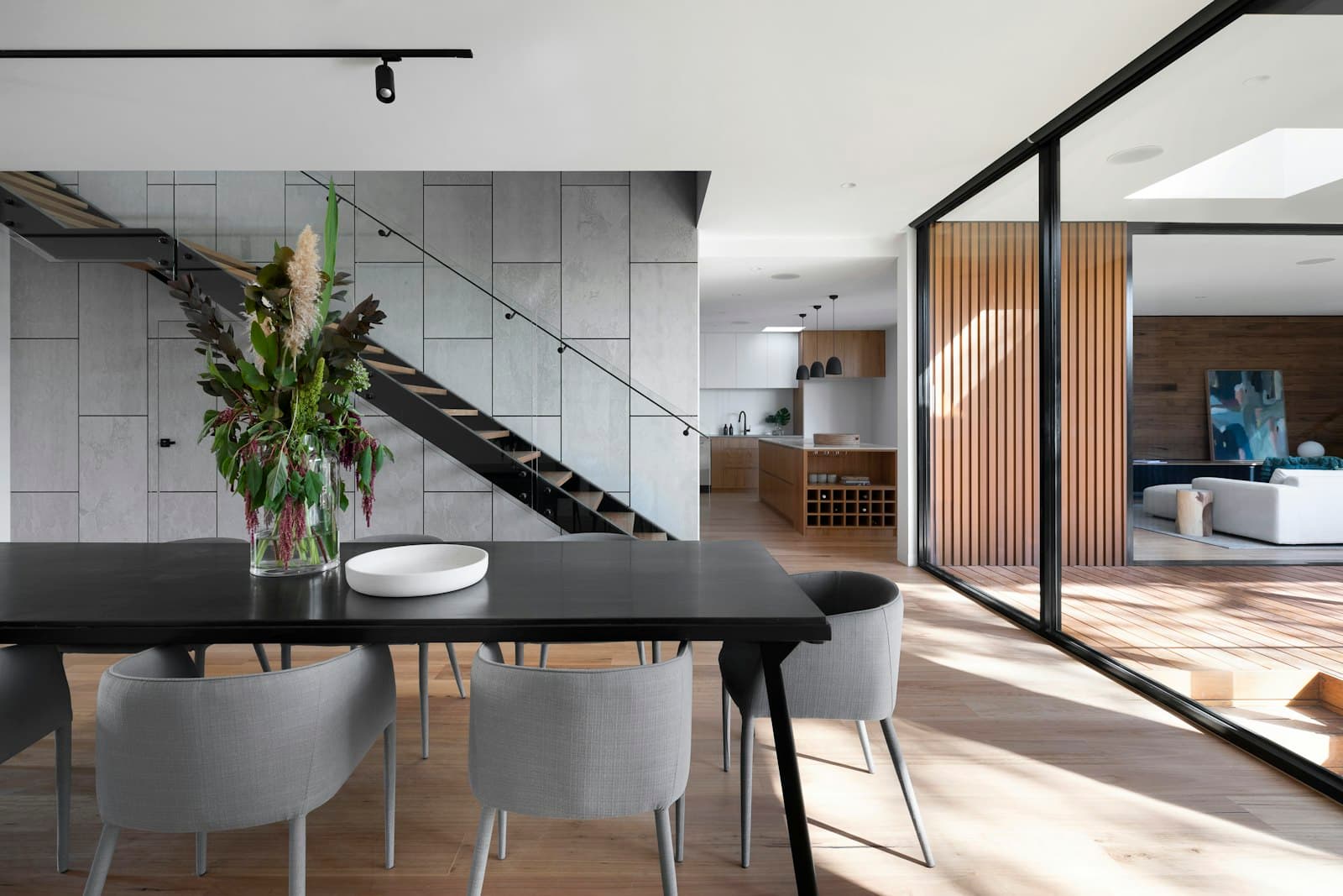 Modern black steel and timber staircase with glass balustrade